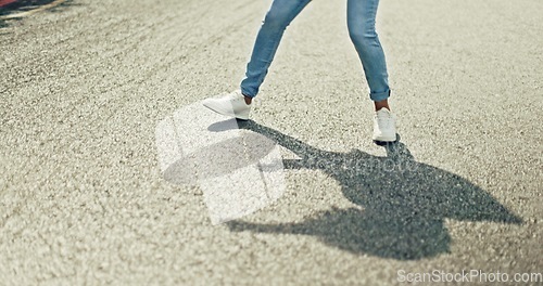 Image of Feet, dancing and woman in city street for celebration, achievement or happy success with shadow or silhouette on asphalt road. Energy, freedom and urban hip hop dancer student girl legs and sneakers