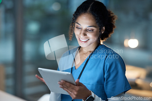 Image of Nurse, medical tablet and black woman in hospital working late on telehealth, research or online consultation. Tech, healthcare or female physician with technology for wellness app in clinic at night