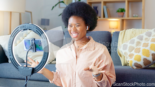 Image of Beauty influencer filming a makeup tutorial at home. Young female blogger live streaming a broadcast online with ring light for a vlog channel. Recording a fun podcast for followers on social media