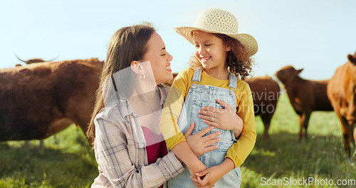 Image of Farming, child and mother with kiss on a farm during holiday in Spain for sustainability with cattle. Portrait of happy, smile and travel mom and girl with love while on vacation on land with cows