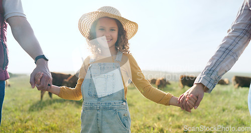 Image of Farmer, family and girl with parents at cattle farm, holding hands and learning about livestock, family business and sustainable living. Love, agriculture and happy family bonding in nature with cows