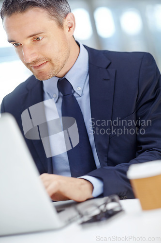 Image of Office, typing and man accountant working on a statistics report on a laptop for a finance company. Success, technology and vertical shot of a businessman planning financial proposal in the workplace