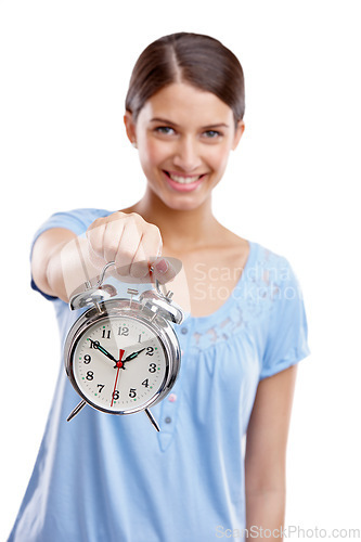 Image of Portrait, clock and time with a model woman in studio isolated on a white background showing an alarm. Hand, vintage reminder with a female holding an alarm clock or timer on a blank space