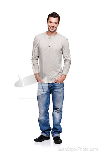 Image of Portrait, smile and man with hands in pocket in studio isolated on a white background looking happy. Pride, cool and model male posing in denim jeans clothes for trendy style and positive mindset