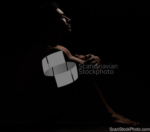 Image of Man, silhouette and black background in a dark studio for depression, mental healthy and anxiety. Model person naked while lonely and thinking about stress, fail or erectile dysfunction problem