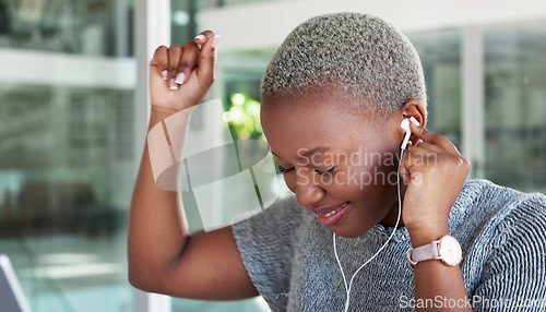 Image of Employee, earphones and listening to music while dancing in an office. Happy, excited and black woman with smile receives good news on her mobile device in corporate business building at work