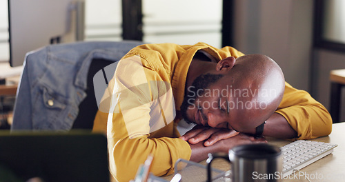Image of Black man, sleep and office desk with tired and fatigue from burnout and working late at small business while exhausted and needing rest. Lazy male at startup company feeling sick and taking nap