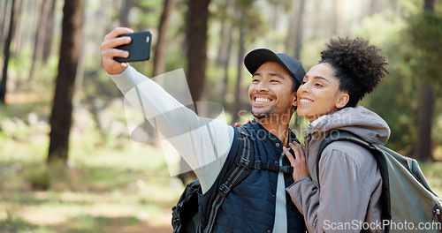 Image of Hiking, selfie and young couple in forest smiling, happy and enjoy nature together. Fitness, wellness and Asian man with black woman taking picture with phone on adventure, trekking and walk in woods