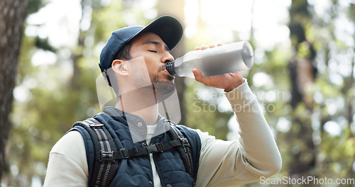 Image of Water, drink and man with fitness hiking, exercise and thirsty in forest, nature and woods. Motivation, health and training with man hydrate after hike in nature environment for health, and wellness