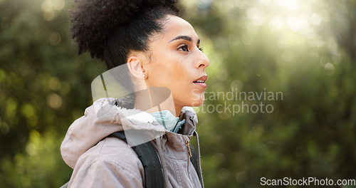 Image of Hiking, thinking and adventure with a black woman in nature, sightseeing while walking on a trail outdoor. Freedom, travel and health with a young female hiker out for discovery and exploration