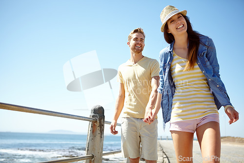 Image of Love, beach and portrait of couple holding hands at the beach for travel, fun and summer vacation. Sea, holiday and young man with woman bond while walking, happy and smile while relaxing in Florida