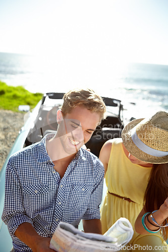 Image of Road trip, adventure and couple with map by ocean on summer holiday, vacation and weekend getaway on car. Travelling, freedom and man and woman reading paper for directions, navigation and journey