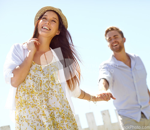 Image of Happy, young couple and holding hands with smile for summer vacation, travel or journey together in the outdoors. Beautiful woman leading her boyfriend by the hand on a sunny day for the holiday