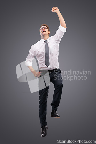 Image of Business, man and jump for celebration, excited and achievement with company, deal and isolated on studio background. Male entrepreneur, employee or consultant happy, promotion or jumping for target