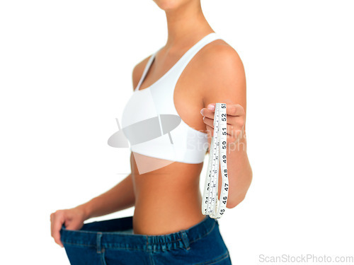 Image of Diet, weightloss and woman with measuring tape, jeans and tummy tuck with skinny waist, cropped and isolated on white background. Fitness, healthcare and wellness, girl with slim figure measurement.