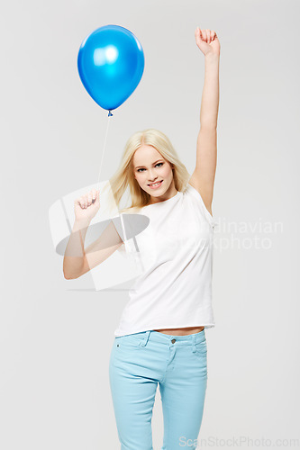 Image of Woman, balloon celebration and studio portrait with hands in air, happiness and winning by white background. Winner model, celebrate and party at event for success, smile and isolated for motivation