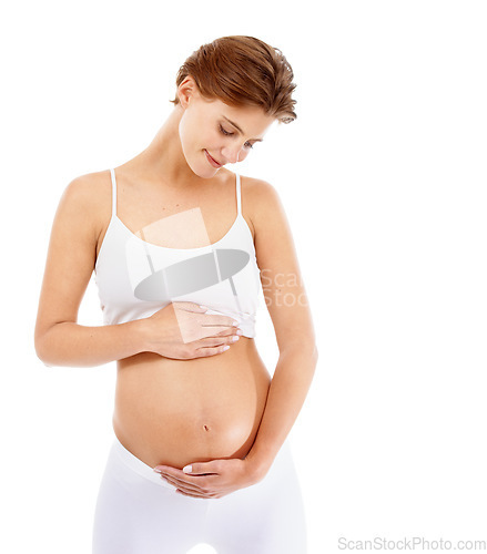 Image of Pregnancy, love and woman holding her stomach in a studio for prenatal care, motherhood and happiness. Maternity, health and happy pregnant female model embracing her tummy by a white background.