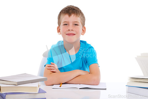 Image of Portrait, school and education with a boy student in studio isolated on a white background for learning or to study. Children, books and mockup with a male pupil sitting at his desk in a classroom