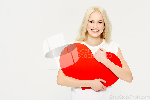 Image of Heart, shape and portrait of woman in studio for love, sign and care against white background. Face, emoji and girl holding an icon for peace, affection and self love with mockup space, happy and joy