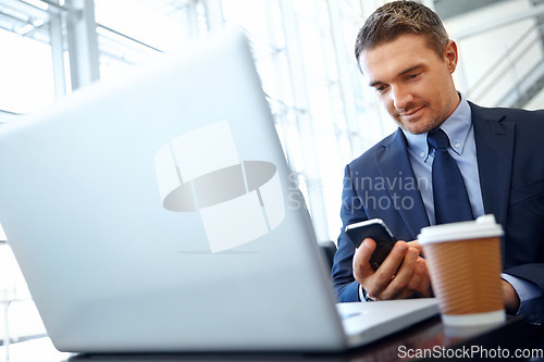 Image of Businessman, laptop and smartphone with company communication or social media with coffee while working. Contact, online and email with networking and worker in professional corporate lounge