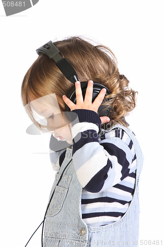 Image of beauty a little girl listening music 
