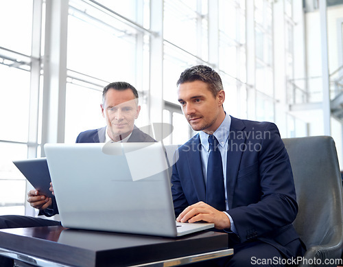 Image of Corporate, laptop and business people in lobby meeting, collaboration or strategy planning on global marketing. Professional businessman, client or partner reading online review for company portfolio