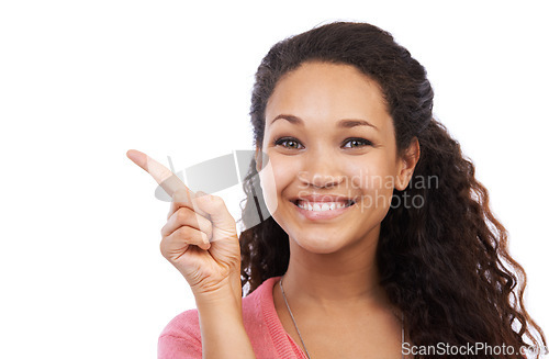 Image of Young black girl, smile portrait and point finger for advertising mockup, marketing and branding in white background. Person, happy face and gesture, happiness and product placement space in studio