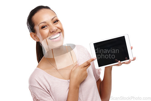 Image of Portrait, pointing and woman with tablet mockup in studio isolated on a white background. Face, marketing and happy female holding touchscreen technology for product placement or advertising space