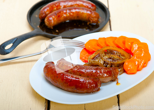 Image of beef sausages cooked on iron skillet