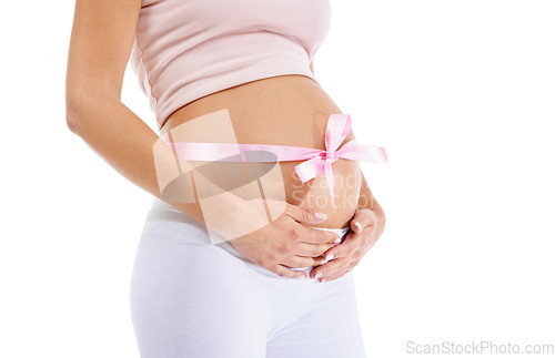 Image of Pregnant woman, pink ribbon and stomach on studio background of maternity health and wellness. Belly, pregnancy and bow of baby shower, girl announcement and gift of life, fertility and future mother