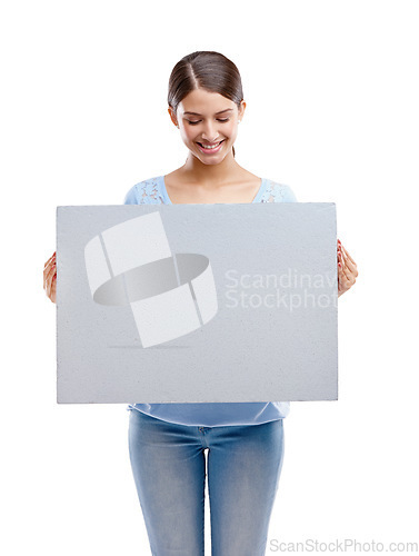 Image of Woman, poster and smile for marketing, advertising or branding against a white studio background. Happy isolated female model holding billboard for message, brand or advertisement on white background