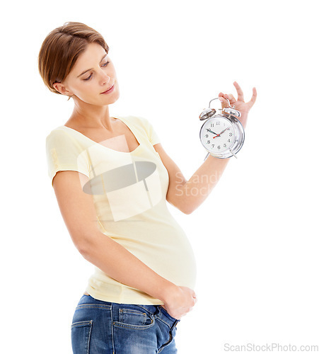 Image of Pregnancy, alarm clock and young woman in studio holding her stomach waiting for the birth of her baby. Maternity, prenatal care and pregnant female model with time clock isolated by white background