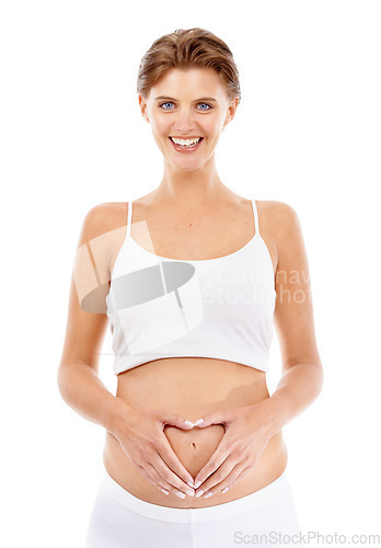 Image of Pregnancy, portrait and mom with a heart on her stomach in a studio for prenatal care, love and happiness. Wellness, health and happy pregnant female model holding her tummy by a white background.