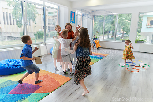 Image of A child hugging a teacher in a modern kindergarten