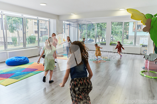 Image of A child hugging a teacher in a modern kindergarten