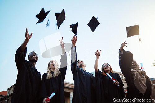 Image of Graduation, education and success with friends in celebration as a graduate group outdoor, throwing mortar caps. Diversity, university and man and woman students celebrating a college diploma