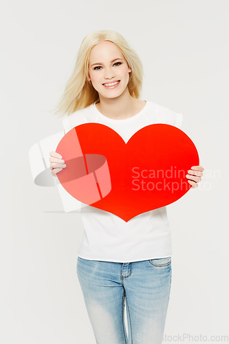 Image of Red heart, love and portrait of woman in studio for peace, self love and affection on white background. Shape, emoji and face of girl holding cardboard sign, loving and gesture with mockup space
