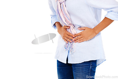 Image of Woman, stomach and pain in discomfort, ache or sore digestion against a white studio background. Isolated female holding belly or painful uncomfortable area suffering from cramps on white background