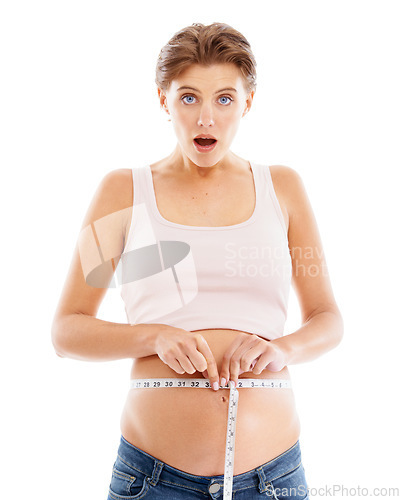 Image of Portrait of shocked pregnant woman with measuring tape on stomach, excited smile on face and white background. Health, wellness and pregnancy, woman measuring baby growth progress in belly in studio.