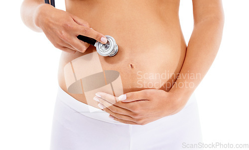 Image of Healthcare, pregnancy and stomach of a woman with a stethoscope on a white background in studio. Baby, abdomen and pregnant woman listening for health of heartbeat of a child on a studio background