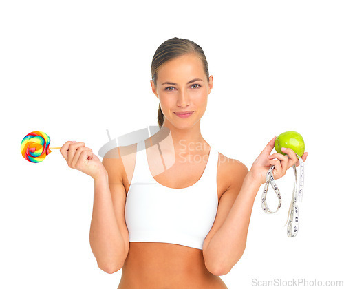 Image of Lollipop, apple and fitness choice of woman in studio isolated on a white background. Face portrait, healthy diet decision and young female model holding candy, fruit vitamins and measuring tape.