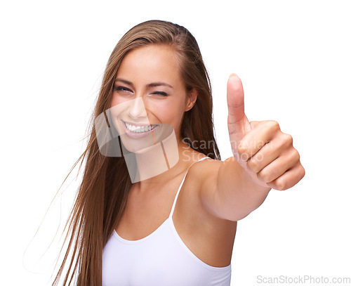 Image of Thumbs up, excited and portrait of a woman with achievement isolated on a studio background. Success, smile and model with a hand emoji sign for agreement, win and goal on a white background