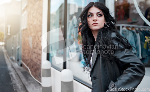 Image of Urban fashion, style and a woman on the street at shop window, punk streetwear outside designer boutique. Beauty, make up and gen z fashion model or rock influencer in the city at store window.