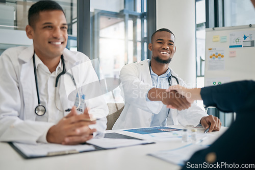 Image of Doctor, handshake and meeting with patient, smile and greeting for vaccination education, talk or help. Black man, doctors and shaking hands with client for wellness, healthcare or medicine in clinic