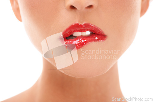 Image of Beauty, makeup and red lips closeup of woman in studio for lipstick, grooming and hygiene on white background. Zoom, mouth and girl with lip gloss product flirt, seductive and bite, isolated and sexy