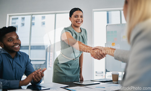 Image of Business people, woman and handshake at meeting, planning and chart on board for target, success or goal. Corporate finance group, applause and celebration for profit, promotion or vision in New York