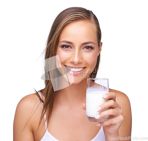 Image of Portrait, calcium and a glass of a milk with a woman in studio isolated on a white background. Health, drink and diet with an attractive young female drinking a beverage for protein or vitamins