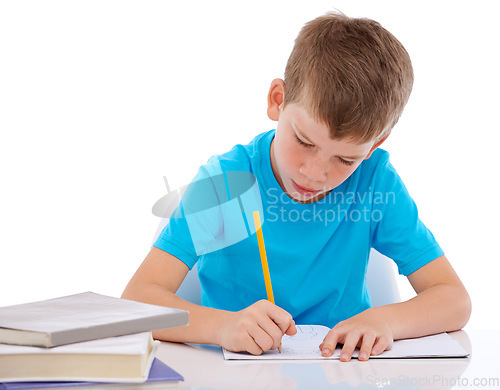 Image of Young boy, writing and learning homework at desk for school, education and student knowledge. Paper, working and child with books for study, creative drawing or academic preschool practice in studio