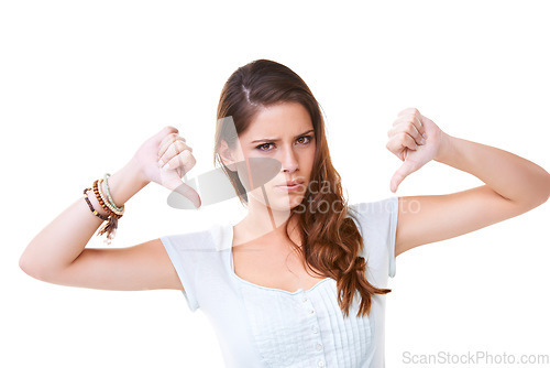 Image of Woman, angry face and thumbs down portrait in studio for sad news, mental health depression and vote no. Model, upset or frustrated hands sign for anger, depressed headshot or negative body language