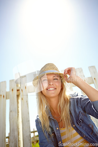 Image of Woman, hat and blue sky in summer garden, park or mockup lens flare. Sunshine, fashion and female relax at field fence, nature and freedom with happiness in environment for holiday, mock up and smile